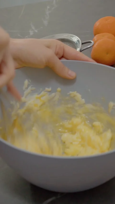 Vertical video Mixing egg and butter for delicious baked goods in a cozy kitchen Stock Footage 329629452