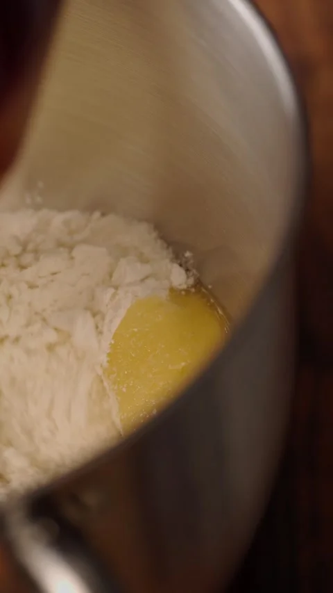 Vertical video, mixing ingredients for making homemade bread in a mixer Stock Footage 282499700