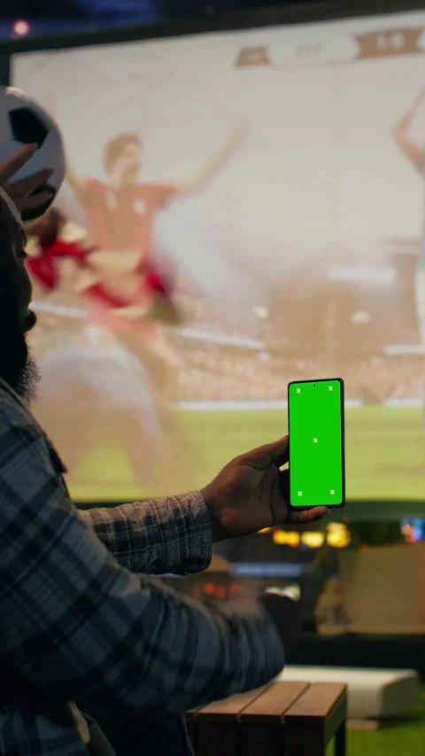 Vertical video Mockup phone used by happy man to bet on soccer match Stock Footage 346784170