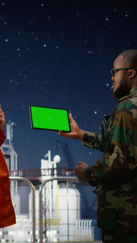 Vertical video Mockup tablet and walkie talkie used by military man on drilling Stock Footage 339888200