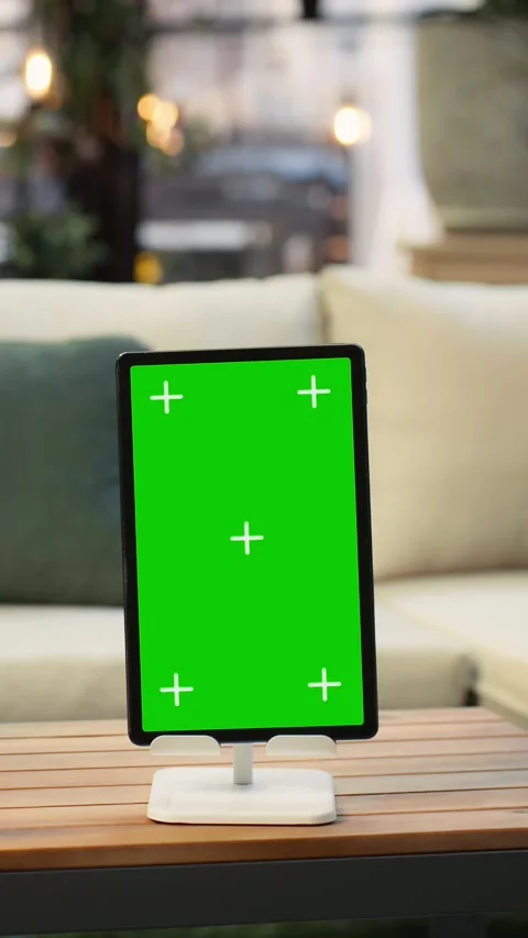 Vertical video Mockup tablet with green screen on rooftop lounge table next to Stock Footage 345166239