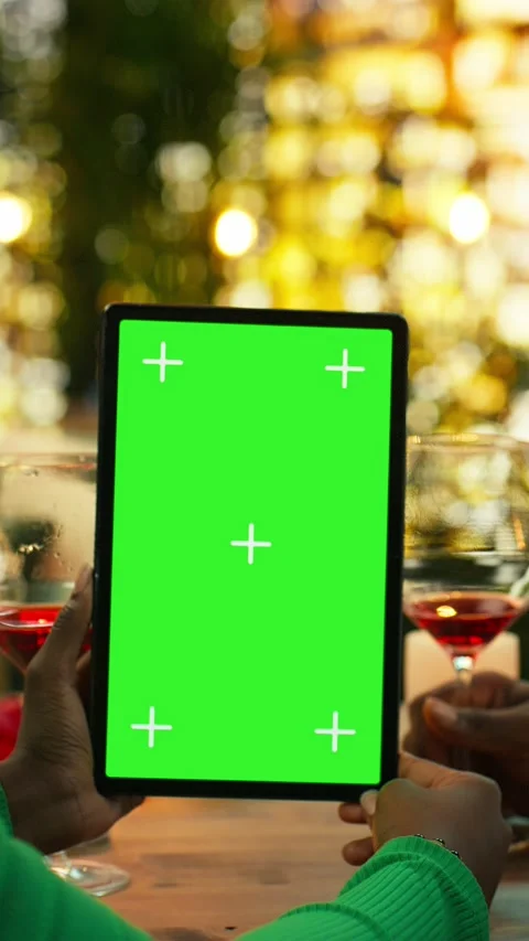 Vertical video Mockup tablet used by couple at candlelit restaurant table Stock Footage 347086070