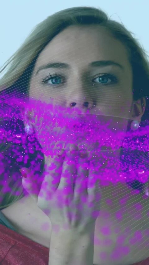 Vertical video: Model lowering hand and blowing kiss, sending magenta cloud and Stock Footage 331199244