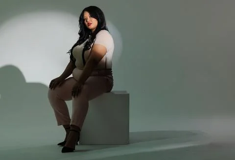 Vertical video: Model posing on white cube while studio lights focusing Stock Photos