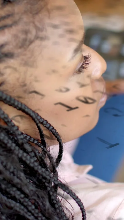 Vertical video: Model in salon, projector shifting text sliding across braids, Stock Footage 333555993