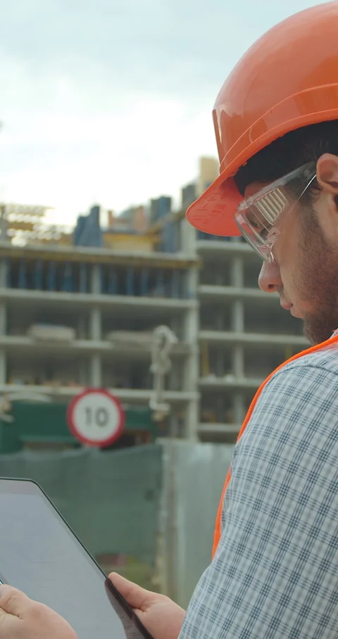 Vertical video. Modern construction engineer or architect in helmet Stock Footage 345503712