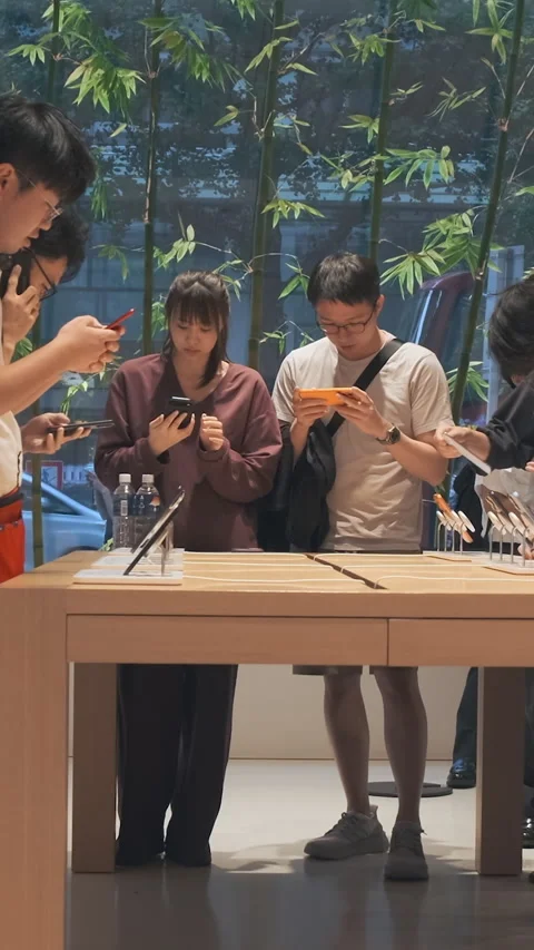 Vertical video: Modern smartphone Apple store showroom, customers explore iPhone Stock Footage 322516117