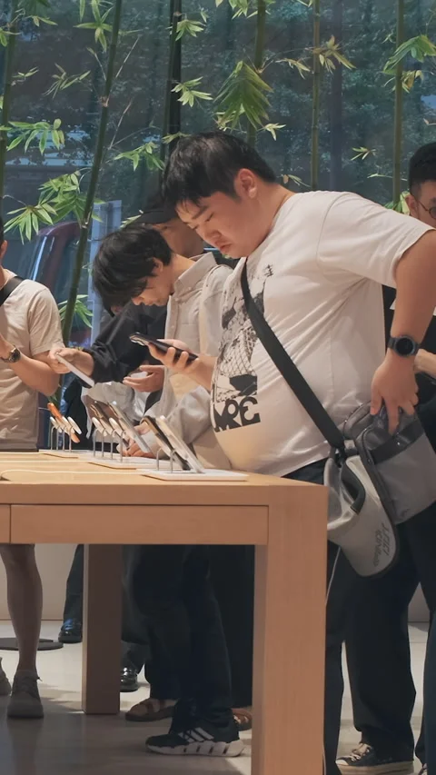 Vertical video: Modern smartphone Apple store showroom, customers explore iPhone Stock Footage 322516118