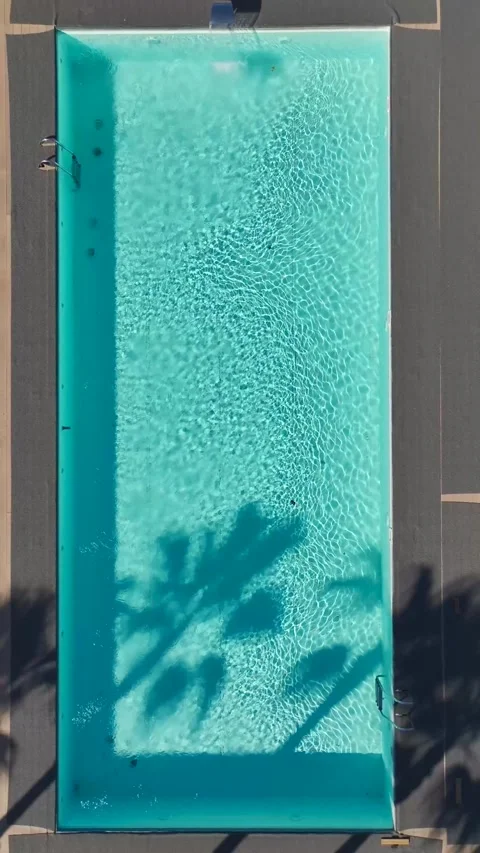 Vertical Video of a Modern Swimming Pool With Bright Blue Water and a Scenic 動画素材 300343553