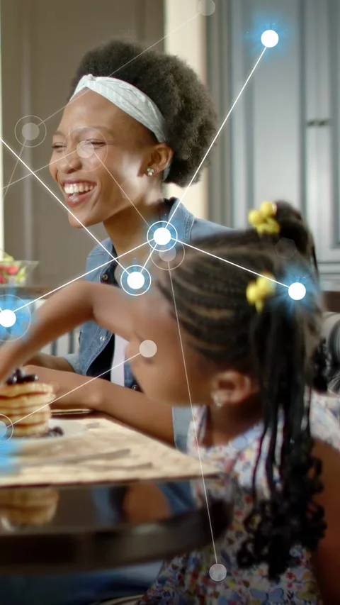 Vertical video: Mom and girl laughing and reaching for pancake reacting to tech Stock Footage 334046869