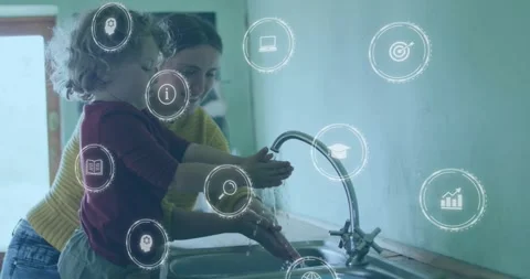 Vertical video: Mom guiding child at sink turning tap and teaching hand hygiene Stock Footage 331565571