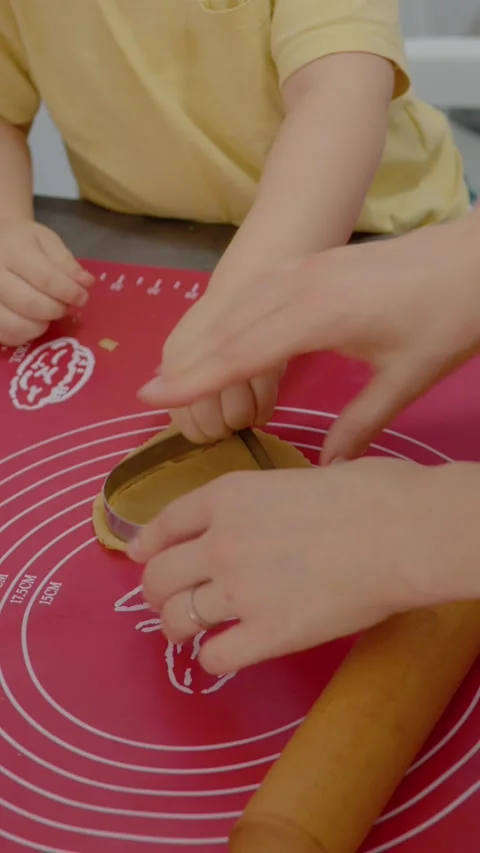 Vertical video Mom shows her young son how to make delicious homemade cookies Stock Footage 329628682