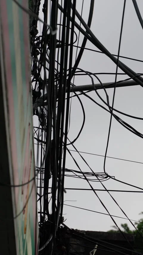 Vertical video of Monkey climbing on tangled electric wires in asian city Stock-Footage 332228530