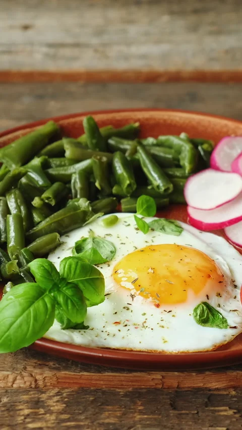 Vertical video. Morning breakfast. Fried egg, fresh tomatoesm, radish and b.. Stock Footage 340333652