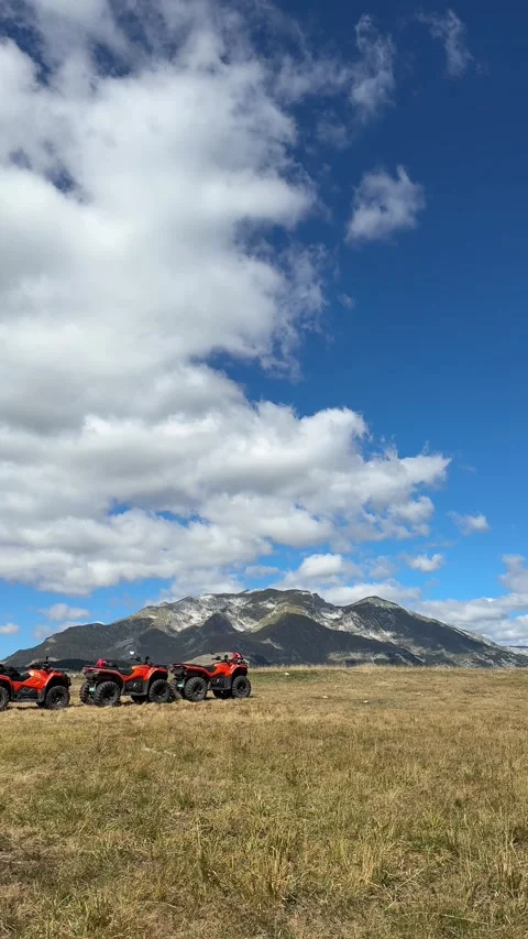 Vertical video of mountain landscape with ATVs under dramatic clouds Stock Footage 319402638