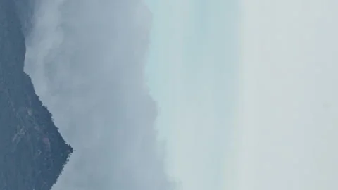 Vertical video of a Moving Clouds And Fog over a mountain range timelapse Stock Footage 145350282