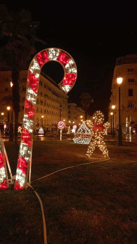 Vertical video moving past glowing Christmas figures in city Stock Footage 345908808
