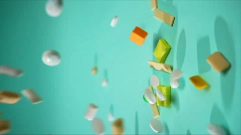 Vertical video multicolored chewing gum falling in slow mo on a blue background Stock Footage 224351668