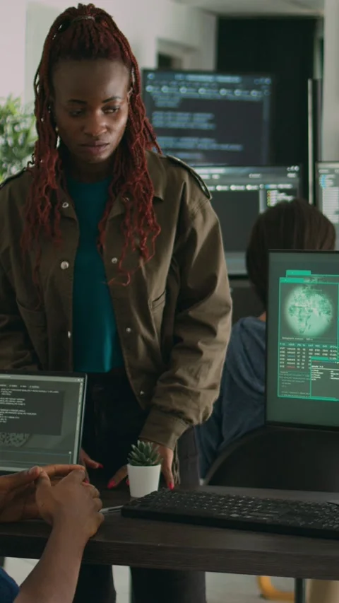 Vertical video: Multiethnic group of program coders dealing with hacked it Stock Footage 218577023