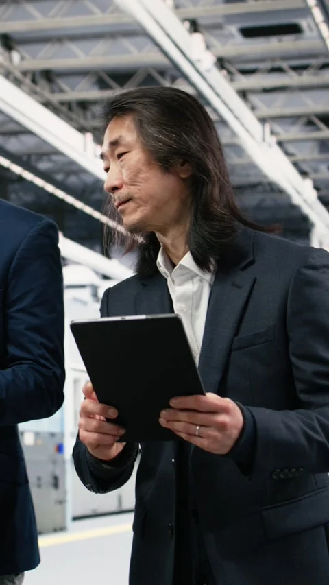 Vertical video Multiethnic manager in semiconductor factory working together Stock Footage 333615255