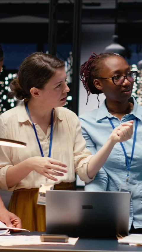 Vertical Video Multiethnic team collaborating in modern office workspace at Stock Footage 334104662