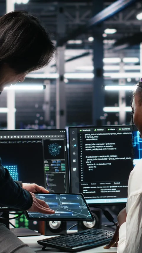 Vertical video Multiethnic team in diverse data center coding with generative AI Stock Footage 313456826