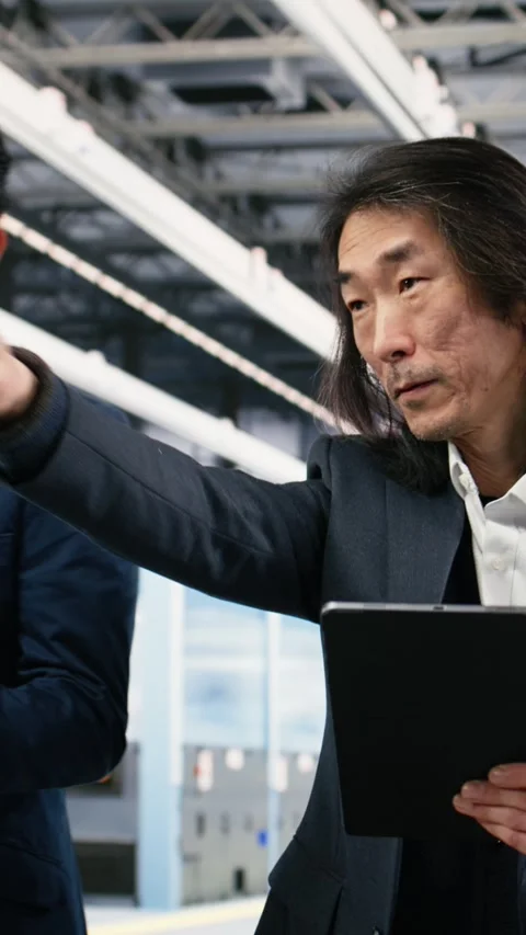 Vertical video Multiracial team of microchip factory managers studying on Stock Footage 333615312