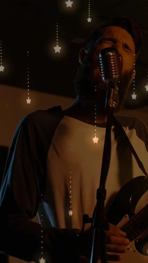 Vertical video: Music singer playing, stepping to mic and singing to move, Stock Footage 332594597