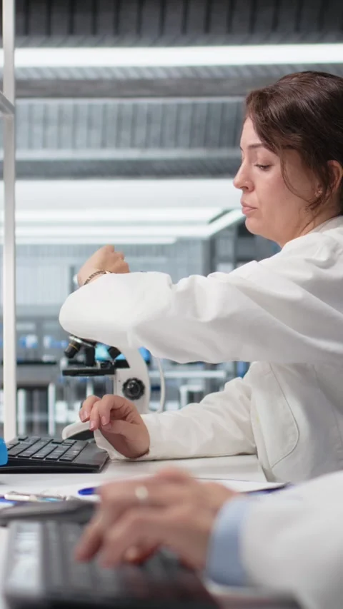 Vertical video Nanotechnology researcher checking time, waiting to finish shift Stock Footage 319505552
