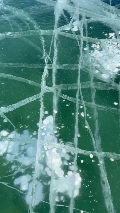 Vertical video of natural ice texture with cracks and bubbles on Baikal Lake Stock Footage 305425835