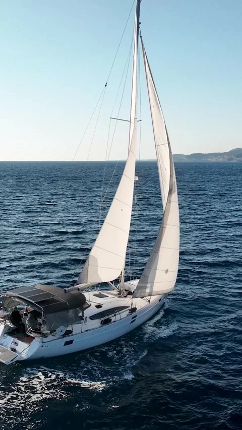 Vertical Video: Nautical Elegance - Yacht's Voyage to the Port on the Stock Footage 245147460