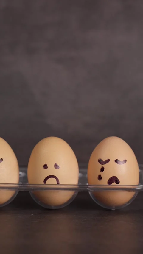 Vertical video, negative emotion sadness, represented by brown eggs Stock Footage 281372788