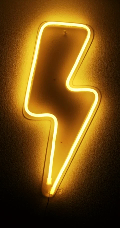 A vertical video of a neon LED lightning bolt figure that hangs on the wall Stock Footage 282812406