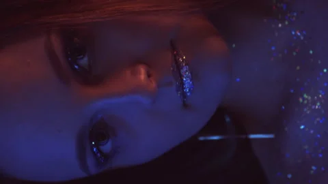 Vertical video neon portrait glitter makeup woman Stock Footage 234480505