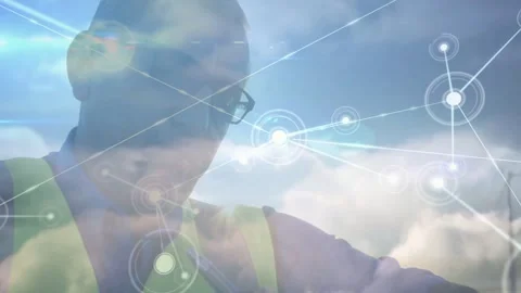 Vertical video: Network emerging, tech in safety vest checking device for data Stock Footage 332544756