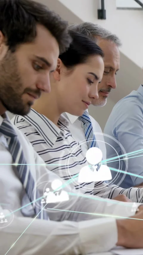 Vertical video: Network overlay showing icons, camera panning left, team writing Stock Footage 334382054