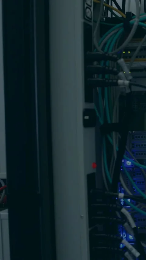 Vertical video: Network rack filling frame, scan overlaying cables and showing Stock Footage 332806804