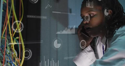 Vertical video: Network tech taking call, troubleshooting rack while monitoring Stock Footage 330547011