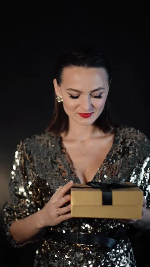 Vertical video. New Year 2023. Glamour brunette woman getting present. Female Stock Footage 223481876