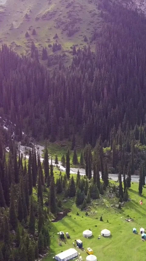 Vertical video: Nomad Yurt Camp with Dreamy Lens Flare Aerial Forward Video stock 332010739