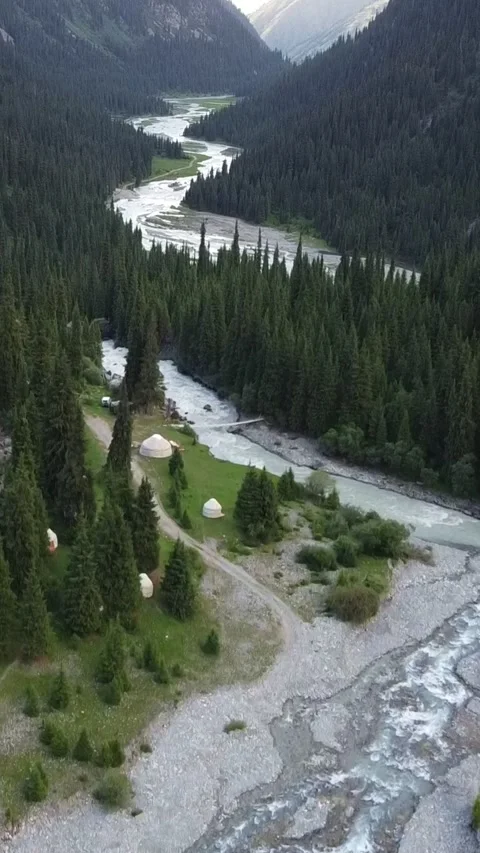 Vertical video: Nomad Yurt Camp by Braided River in Deep Mountain Gorge Video stock 332205289