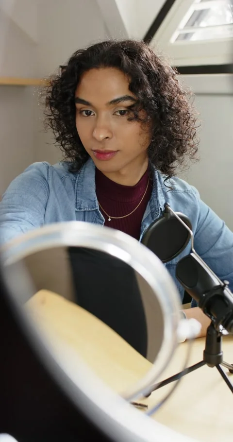 Vertical video: Non-binary artist in loft angling mirror, ring light for shot, Stock Footage 345128992