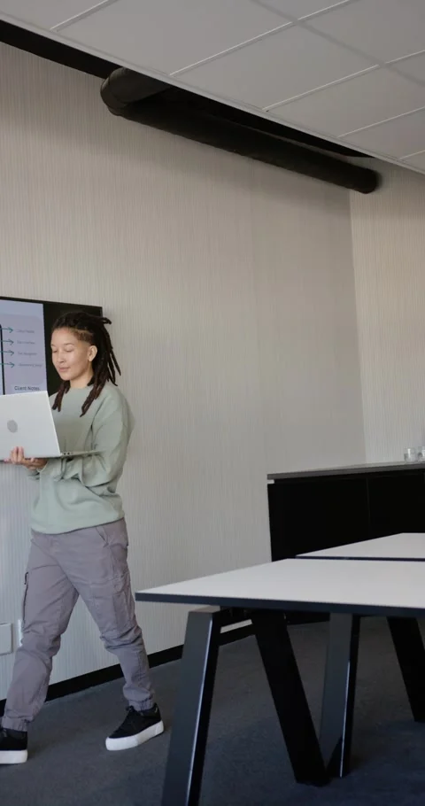 Vertical video: Nonbinary African presenter entering left with laptop, Stock Footage 344695542
