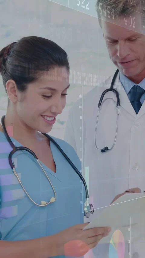 Vertical video: Nurse reading chart, doctor annotating for health review, 库存影片 334550360