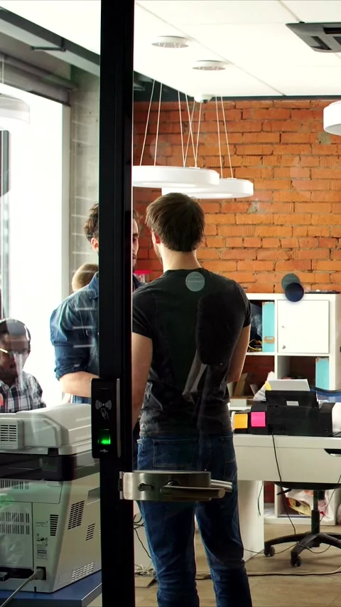 Vertical video, Office environment buzzes with enthusiasm and teamwork, Dynamic Stock Footage 323417520