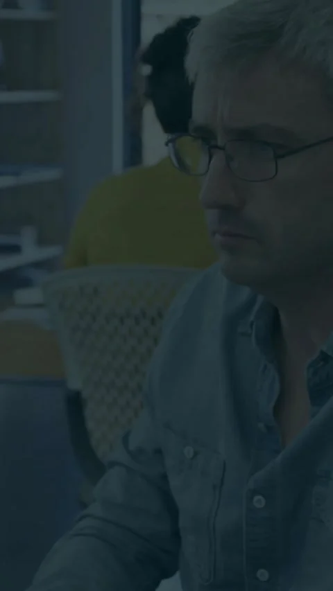 Vertical video: Office man viewing tech update sparking bar chart overlaying Stock Footage 331790274