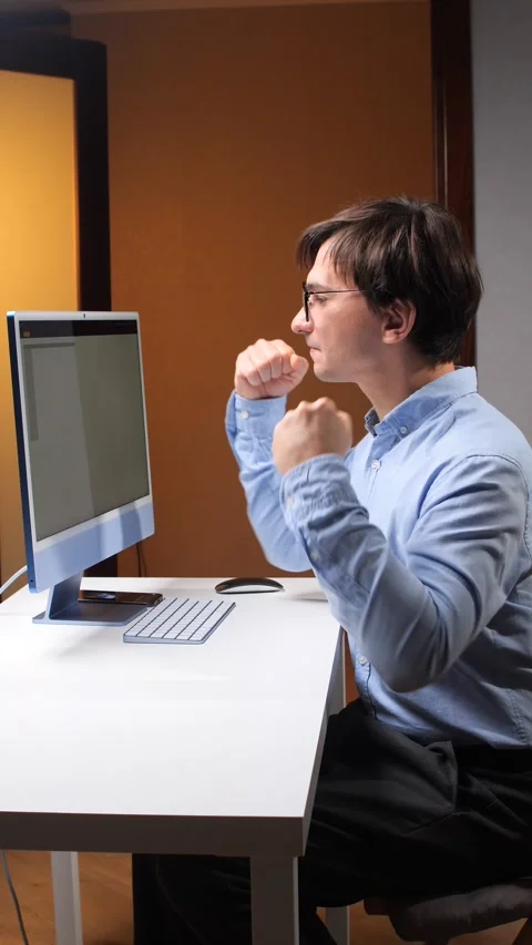 Vertical video office worker celebrating a breakthrough at his computer Stock Footage 348449618