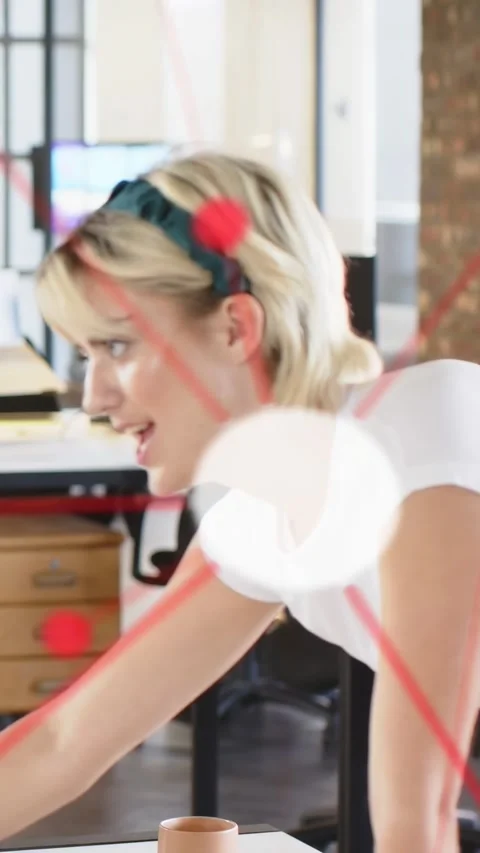 Vertical video: Office worker leaning over desk pointing pen causing animated Stock Footage 333304824