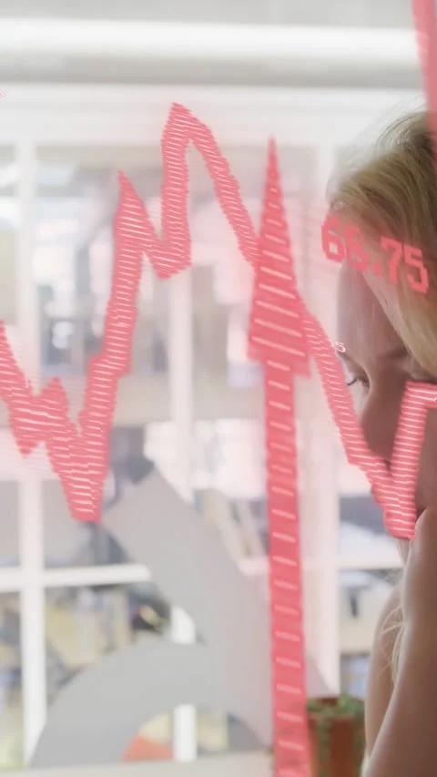 Vertical video: Office worker viewing data update, red wave moving across glass Stock Footage 333978158