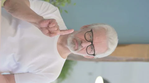 Vertical Video of Old Man Denying Offer in Office Stock Footage 230533548